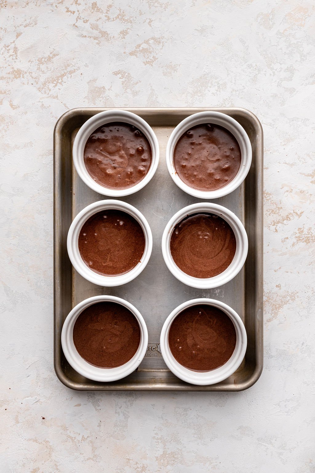 chocolate lava cakes in ramekins ready to bake.