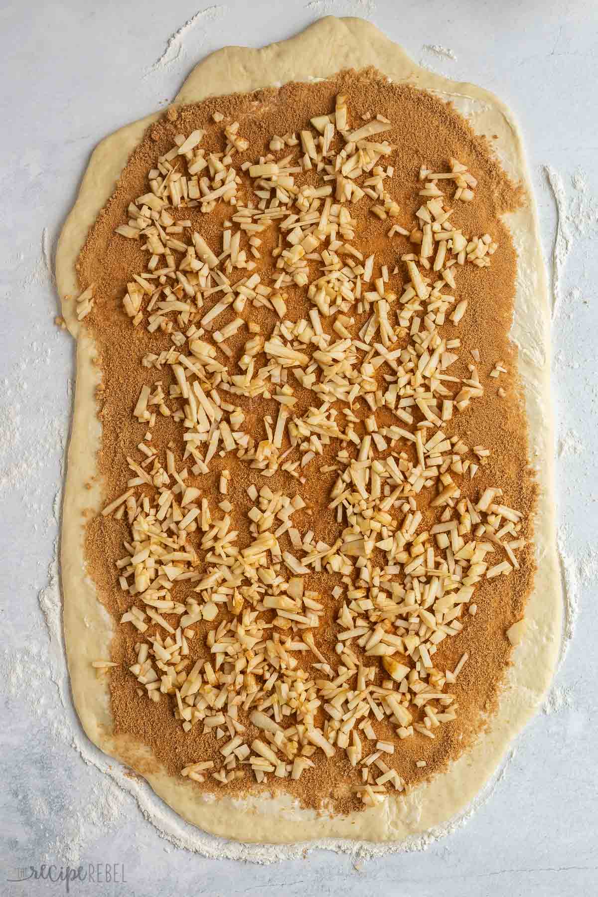 dough rolled out with cinnamon sugar and finely chopped apples.