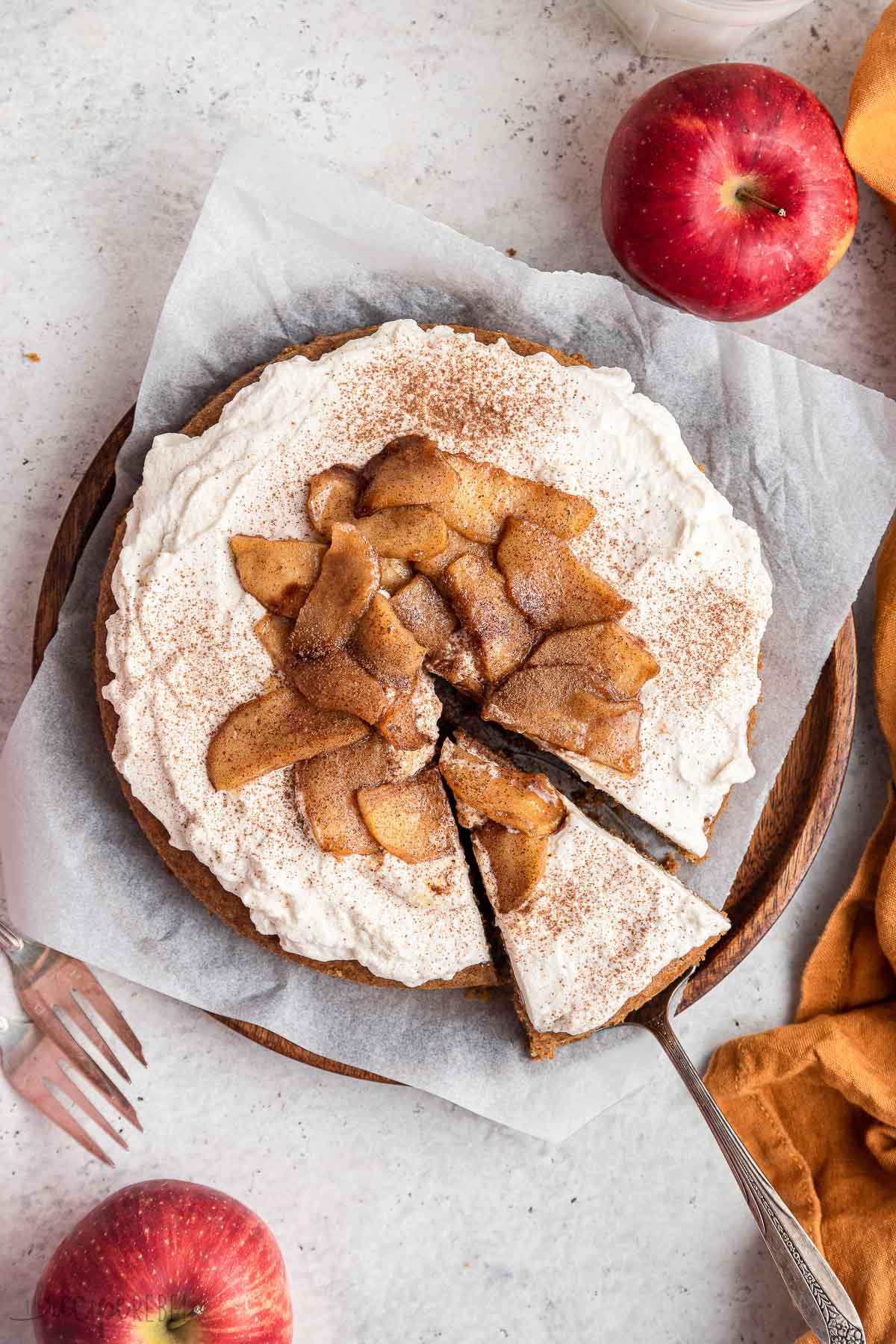 overhead image of one slice of apple cake being removed with server.