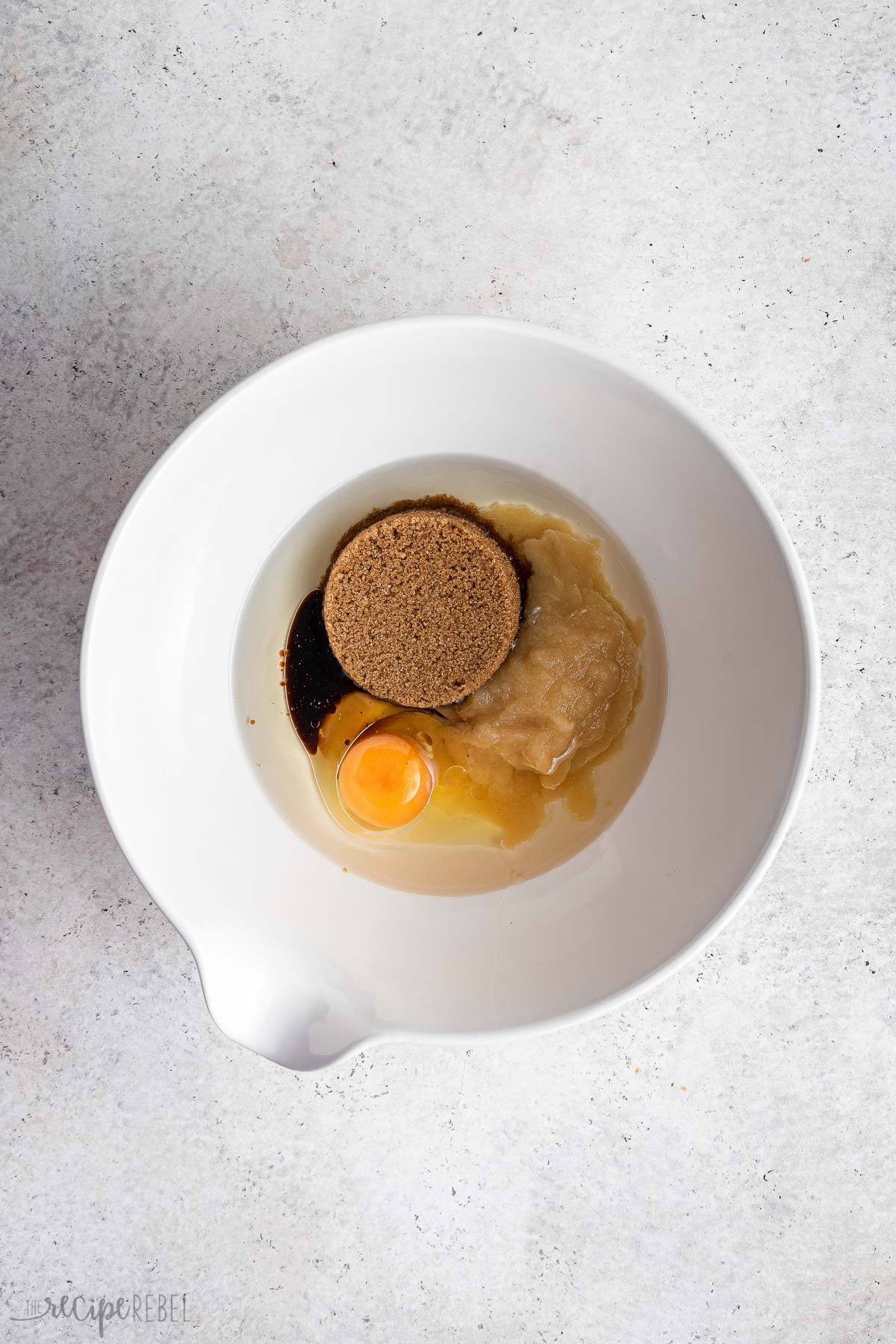 wet ingredients for apple cake in white bowl.