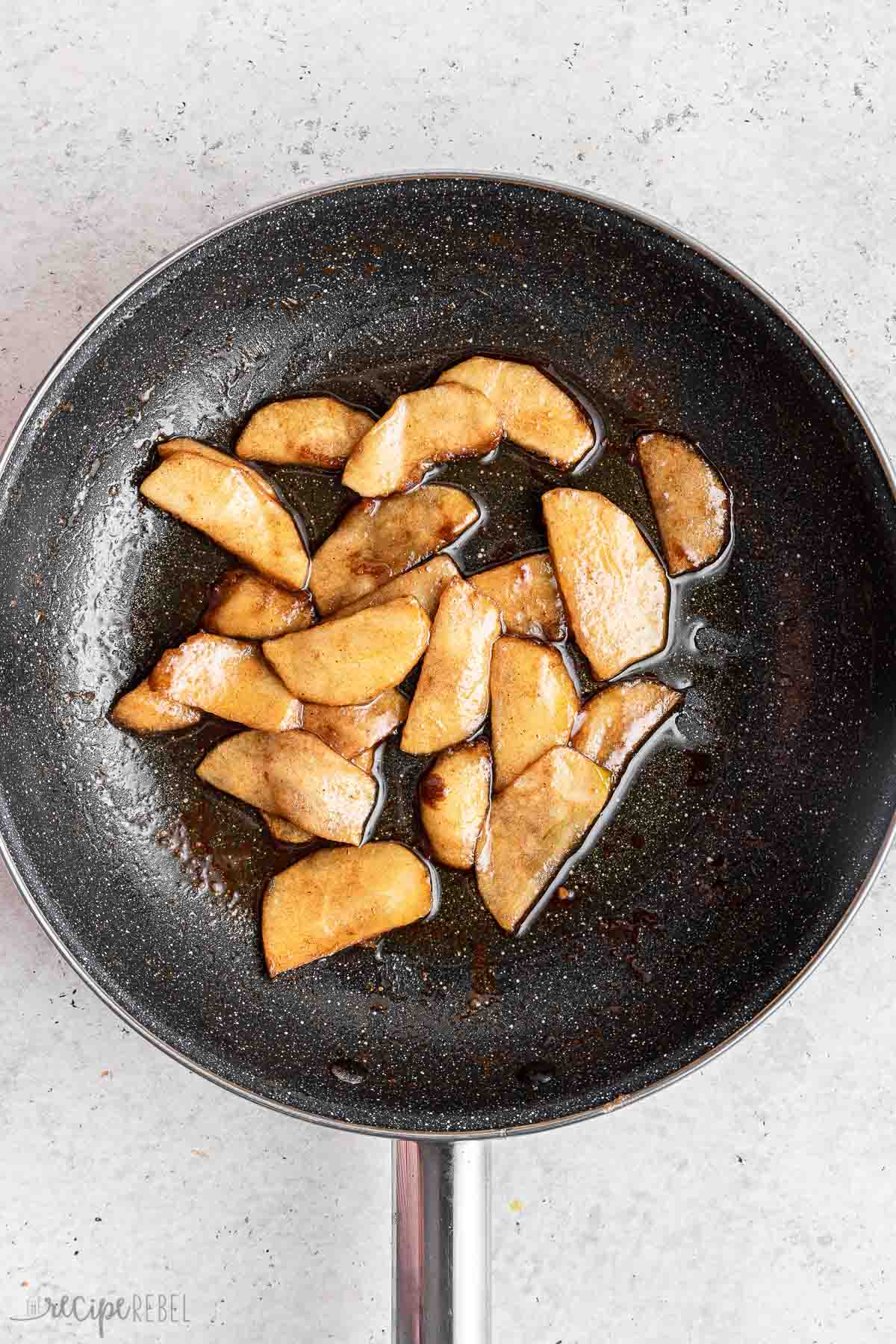 sauteeing apple slices for topping apple spice cake.