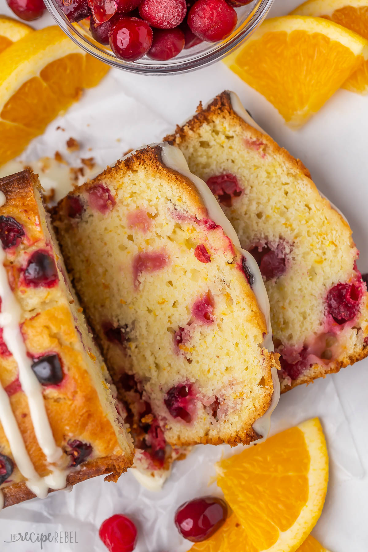 two slices of orange cranberry bread cut from loaf.