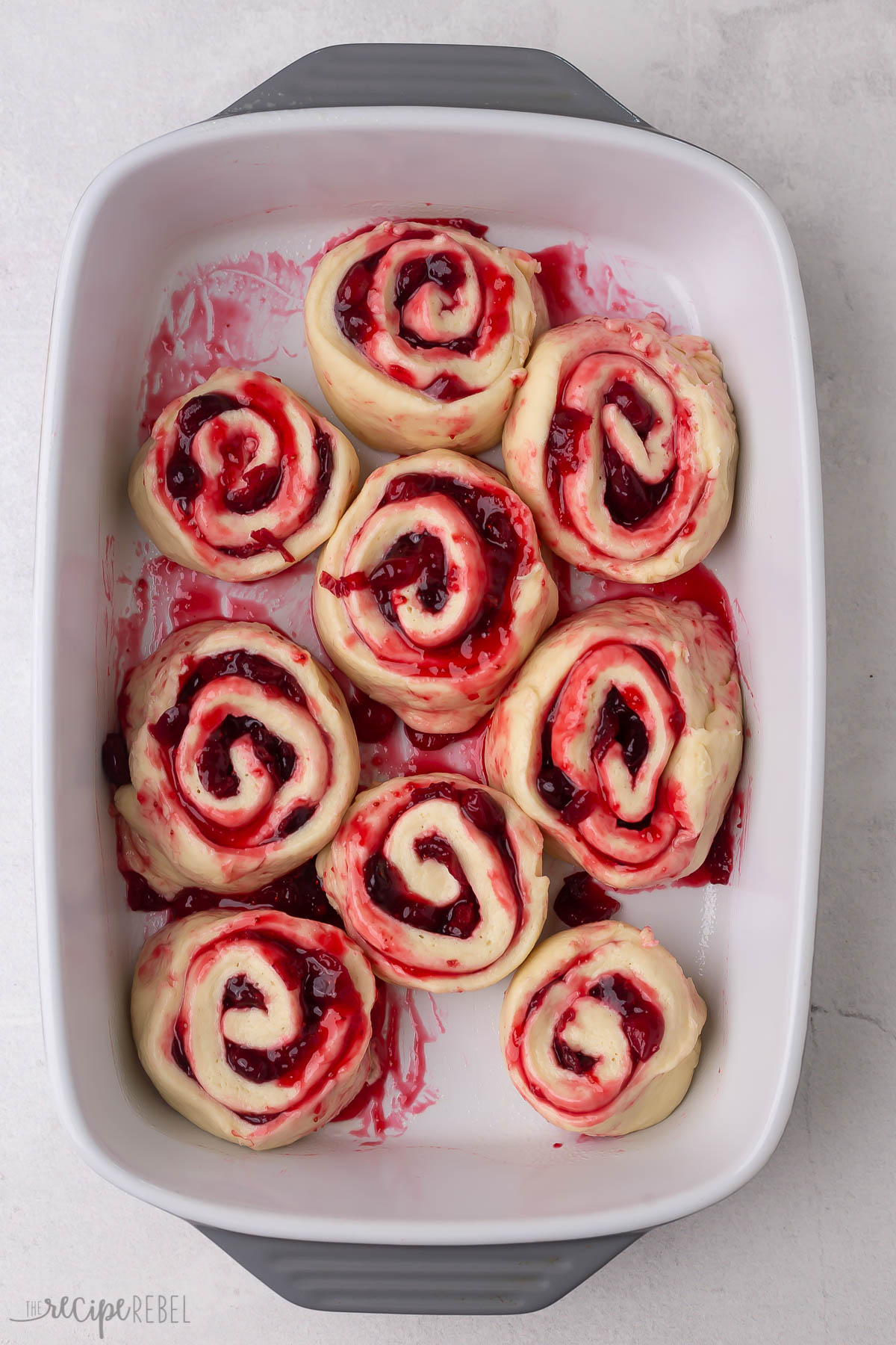 cranberry rolls sliced and in baking dish.