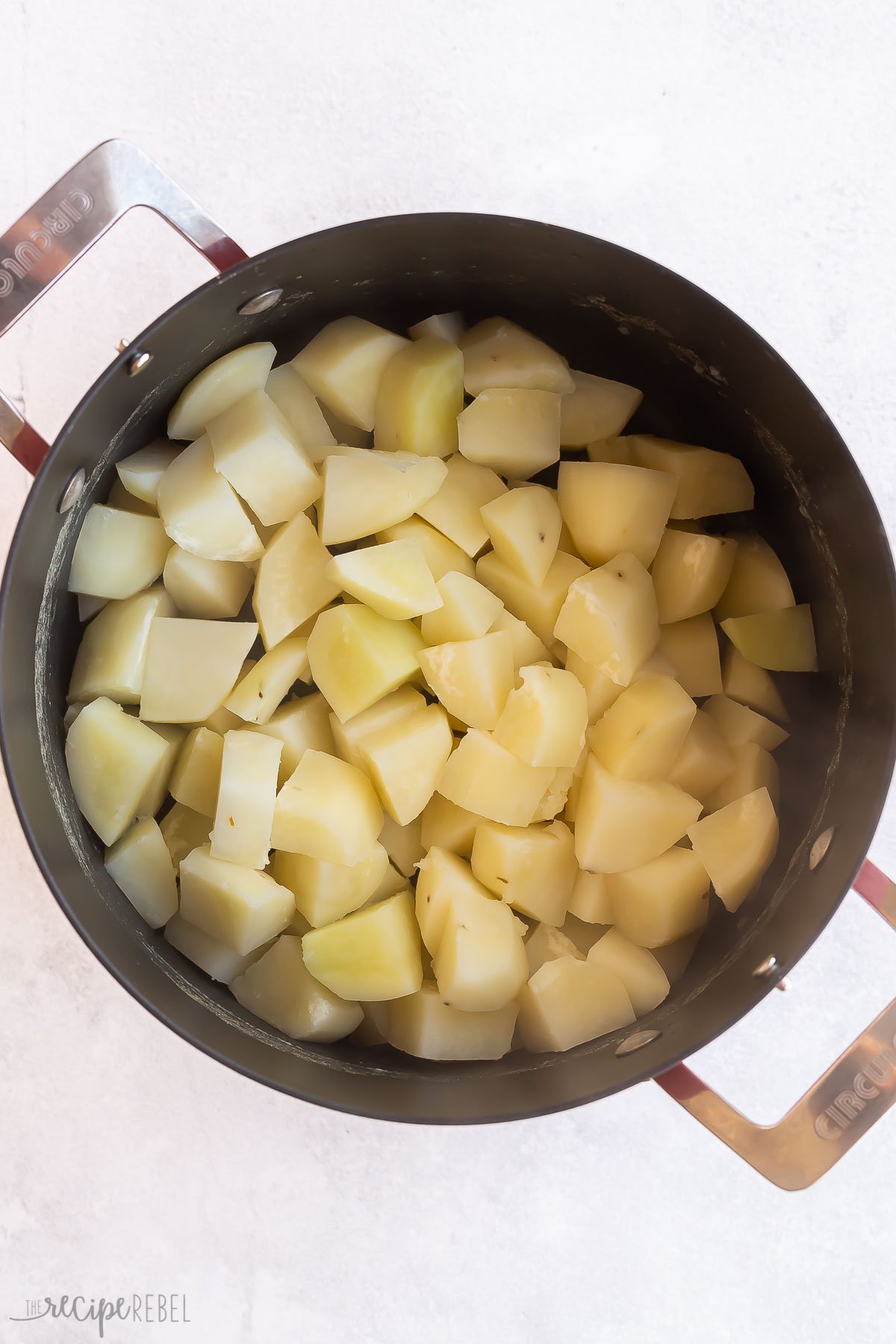 cubed potatoes in pot cooked and drained.