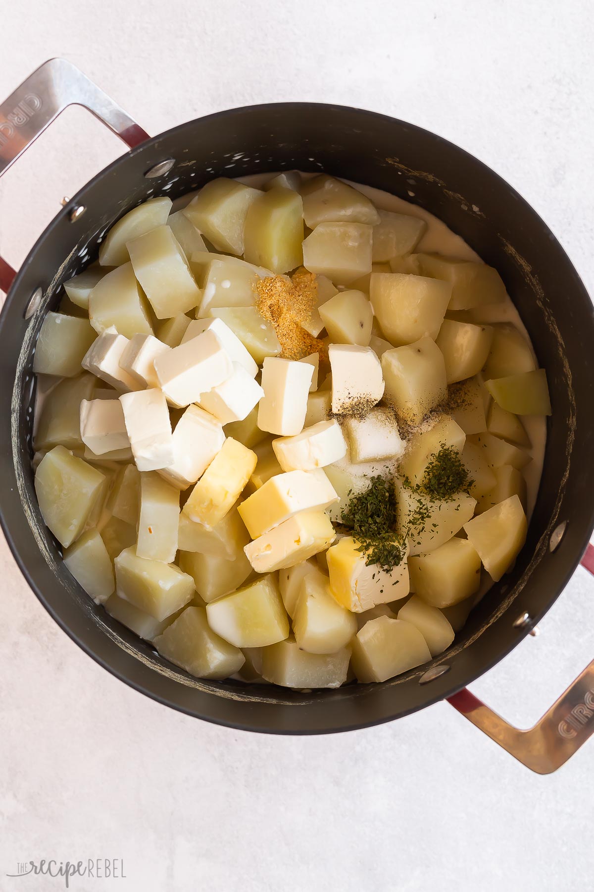 cream cheese butter and seasonings added to cooked potatoes.