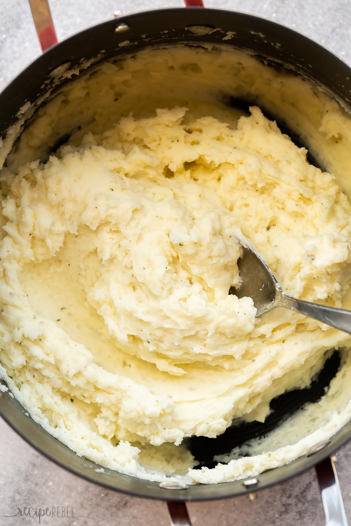 close up of finished mashed potatoes in black pot.