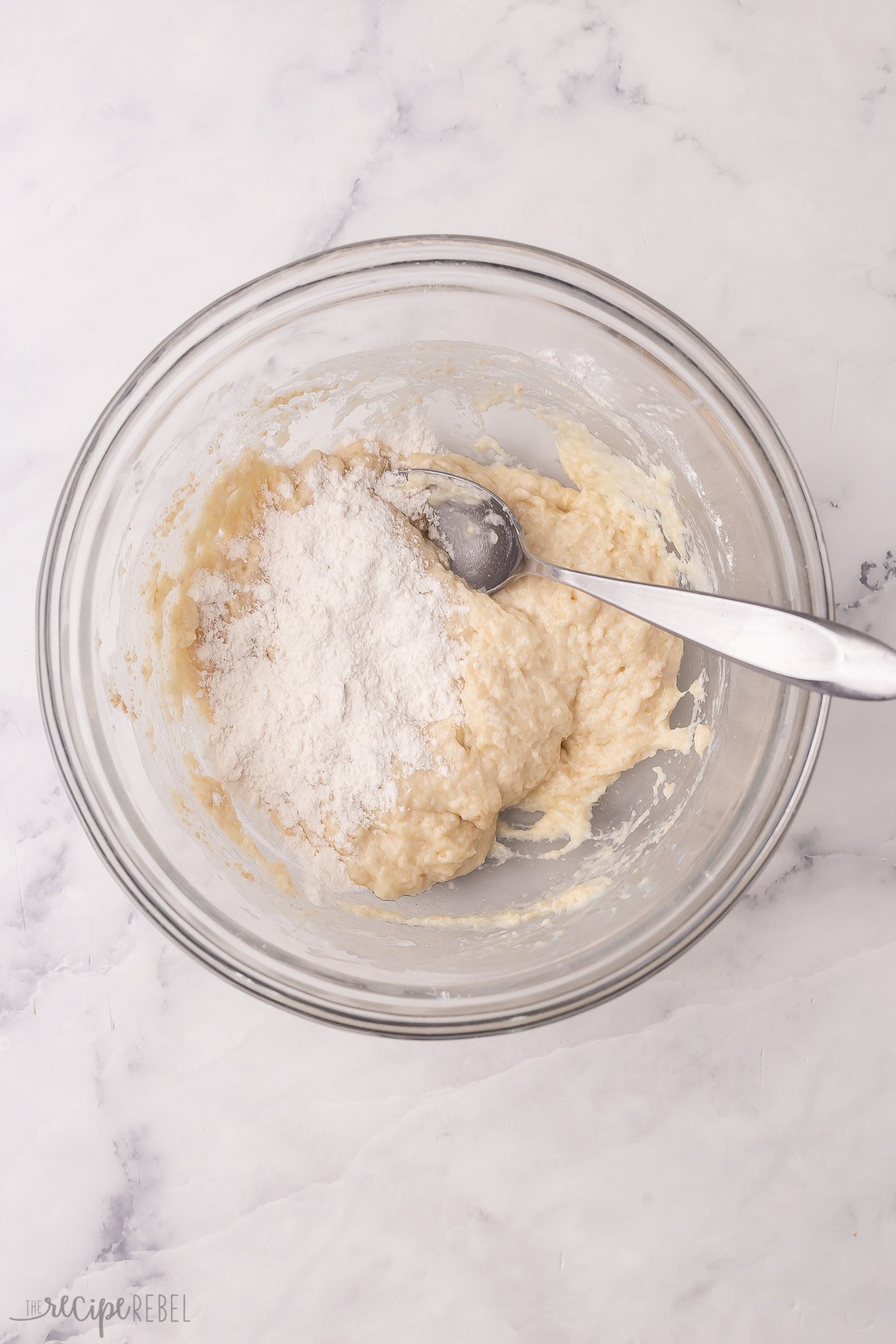 flour gradually being added to dough until no longer sticky.