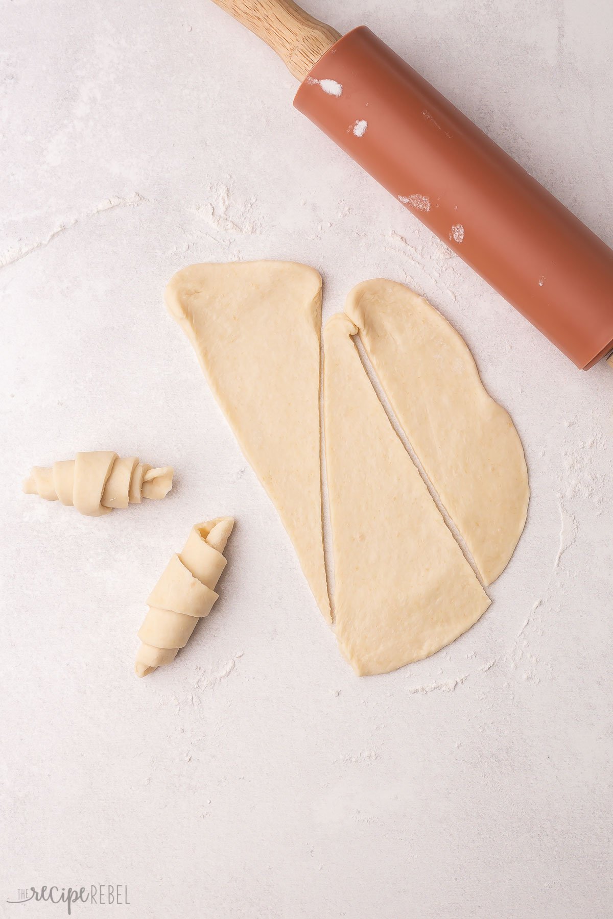 dough rolled out with rolling pin cut into triangles.
