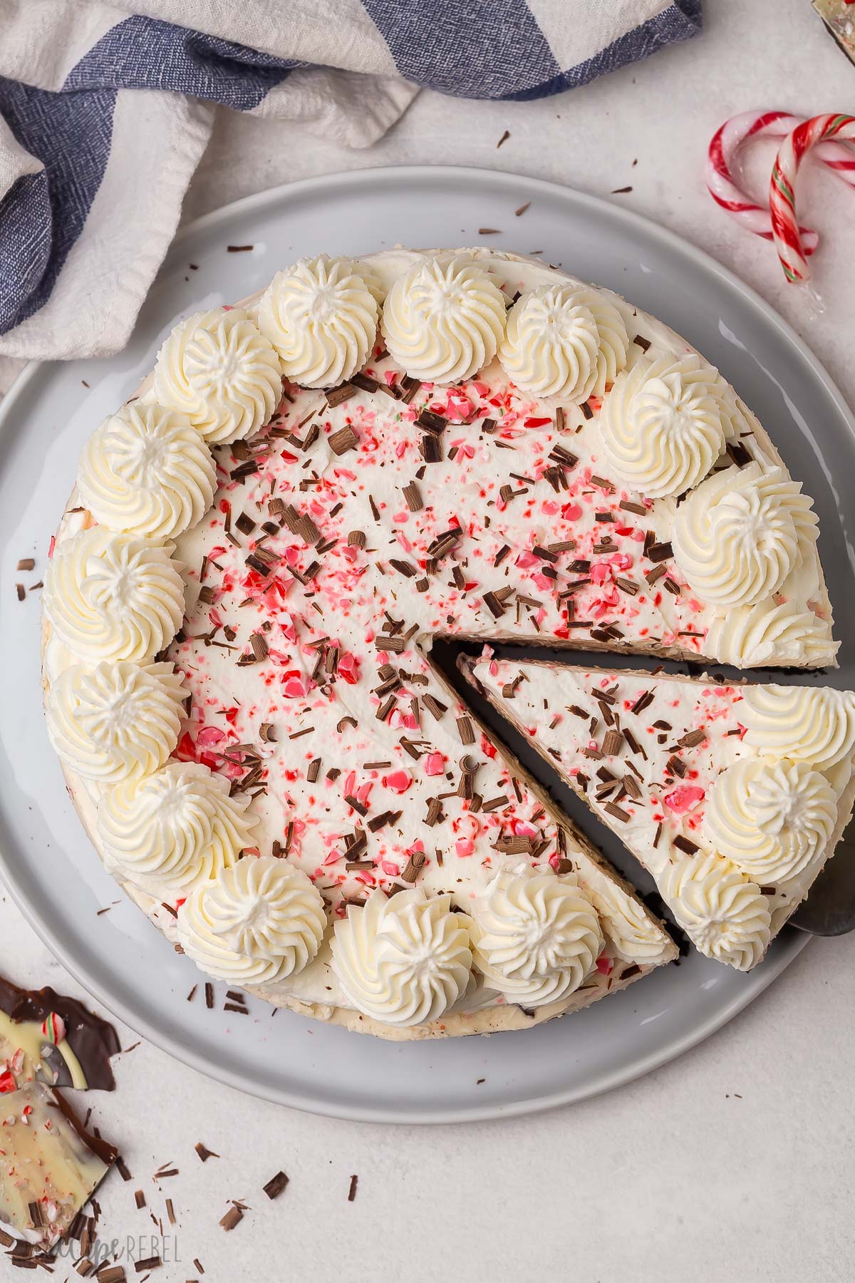 overhead image of one slice of peppermint cheesecake being removed.