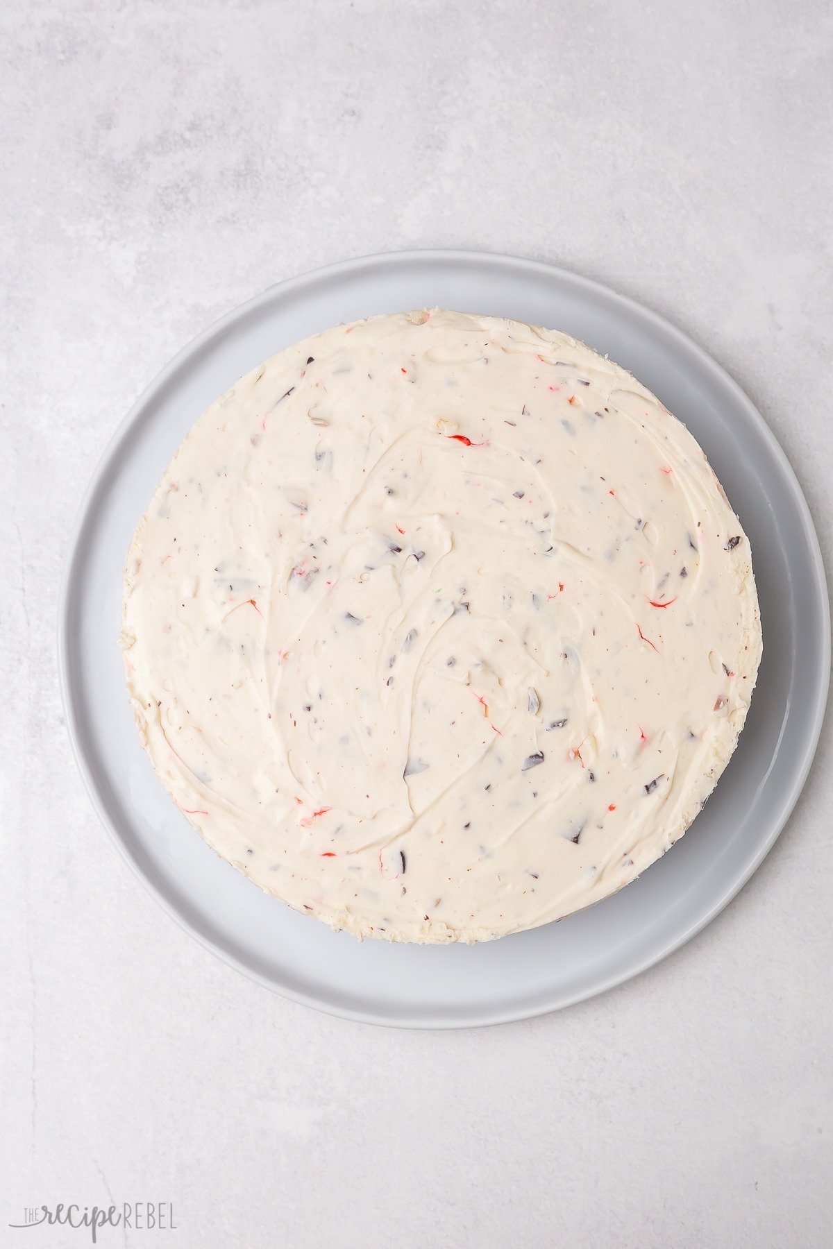 finished peppermint bark cheesecake ready to garnish.