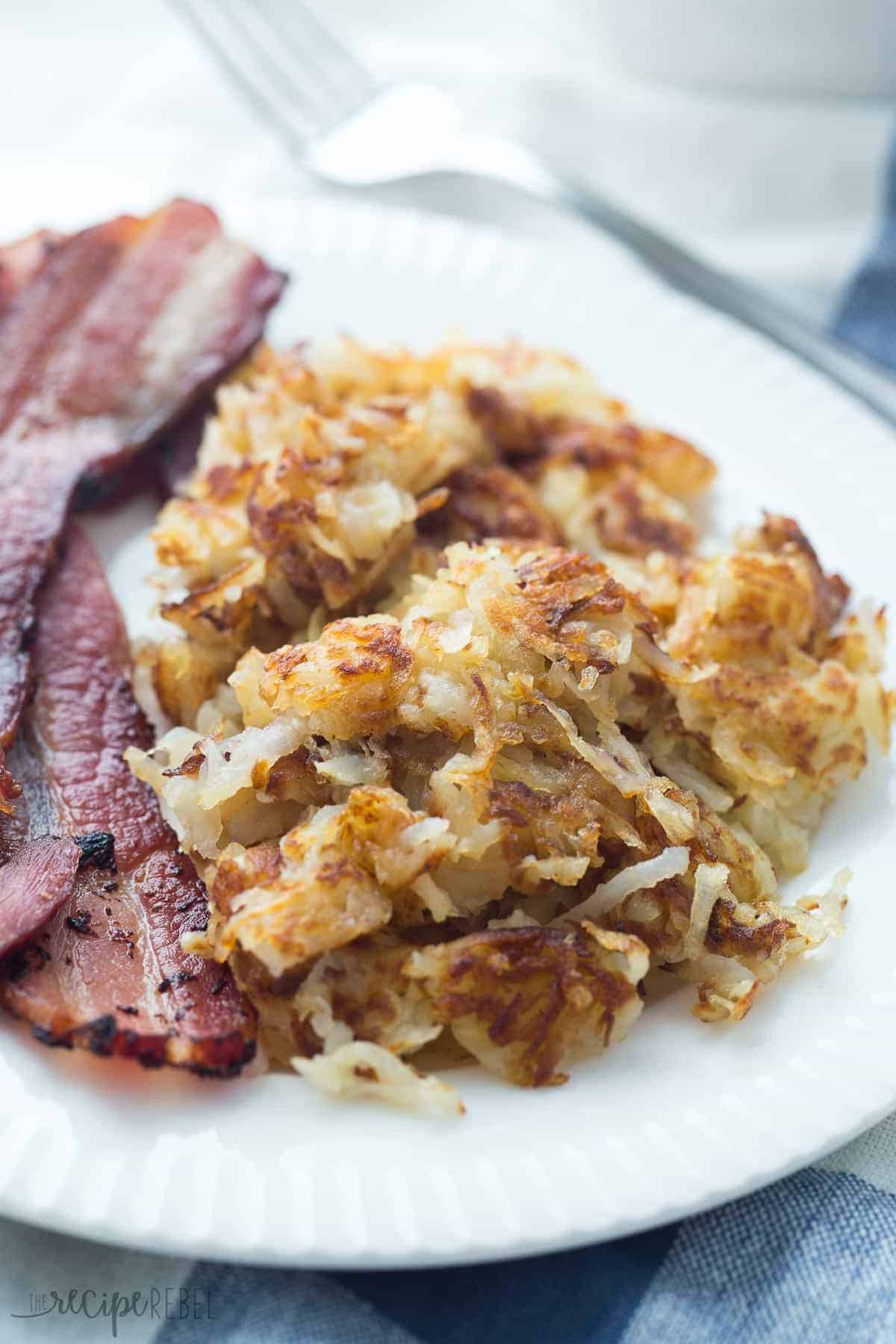 crispy shredded hashbrowns on white plate with bacon