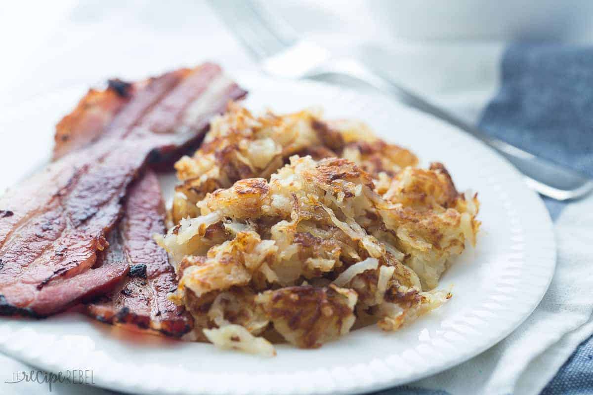 crispy shredded hashbrowns with crispy bacon on white plate landscape image