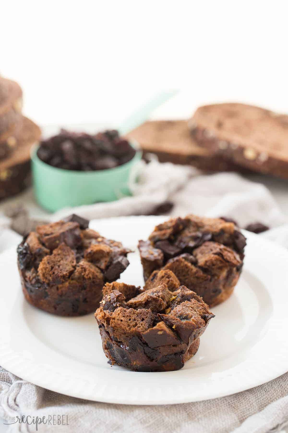 individual chocolate cherry french toast muffins on white plate with bread and cherries in the background