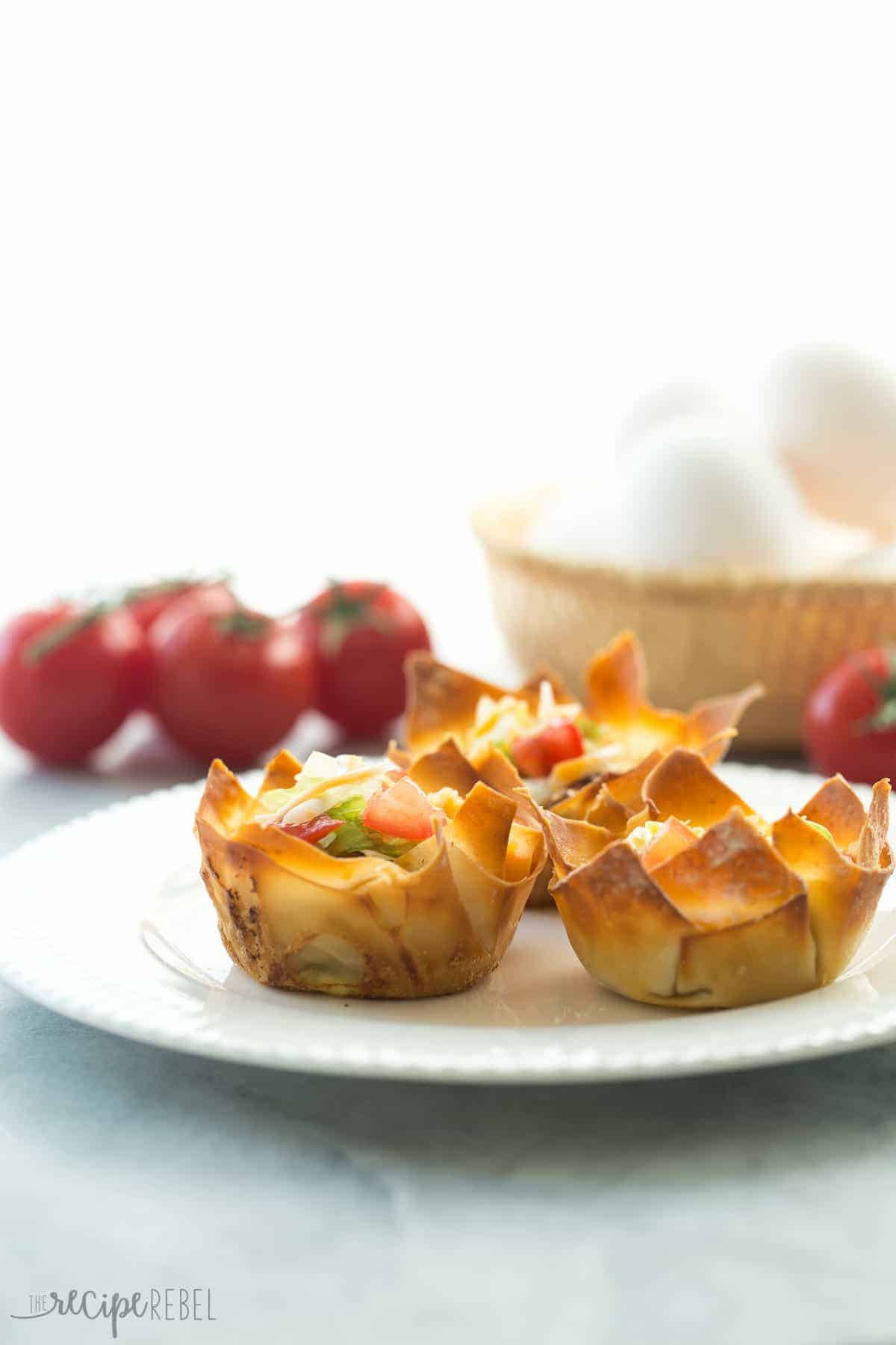 mini mexican wonton quiche with tomatoes and whole eggs in the background