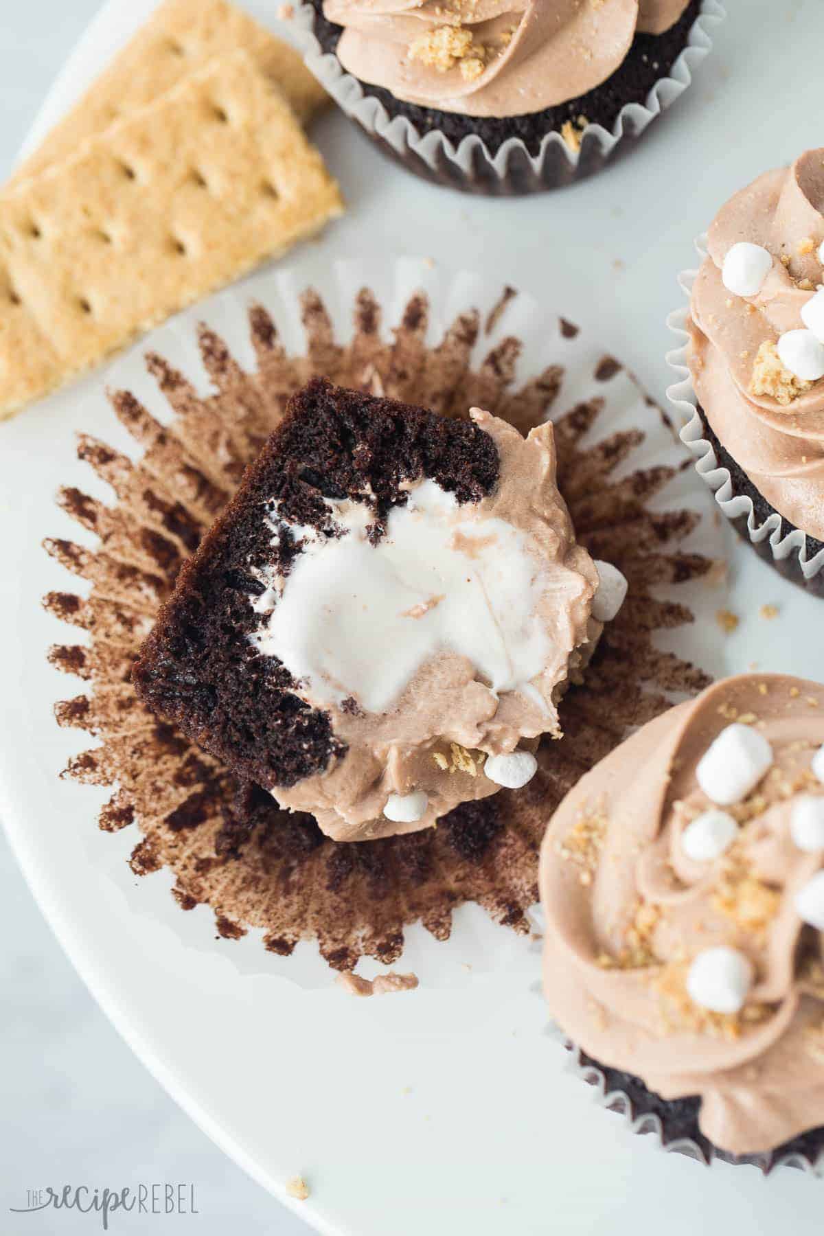 nutella smores cupcake cut in half lying on cupcake wrapper