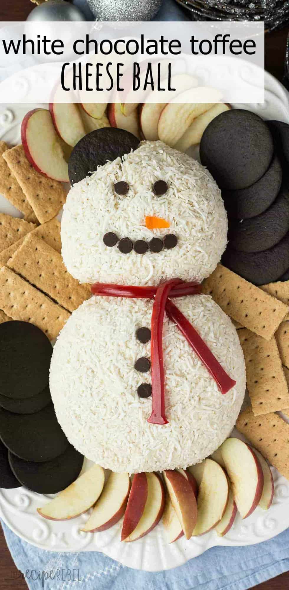 white chocolate toffee cheese ball formed into a snow man covered in coconut and decorated with chocolate chips and licorice