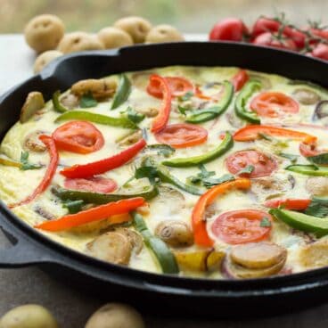 This Spanish Tortilla is really just a Spanish omelette -- made with sliced potatoes, onions and peppers fried together before being topped with beaten eggs and baked. It's perfect festive holiday breakfast!