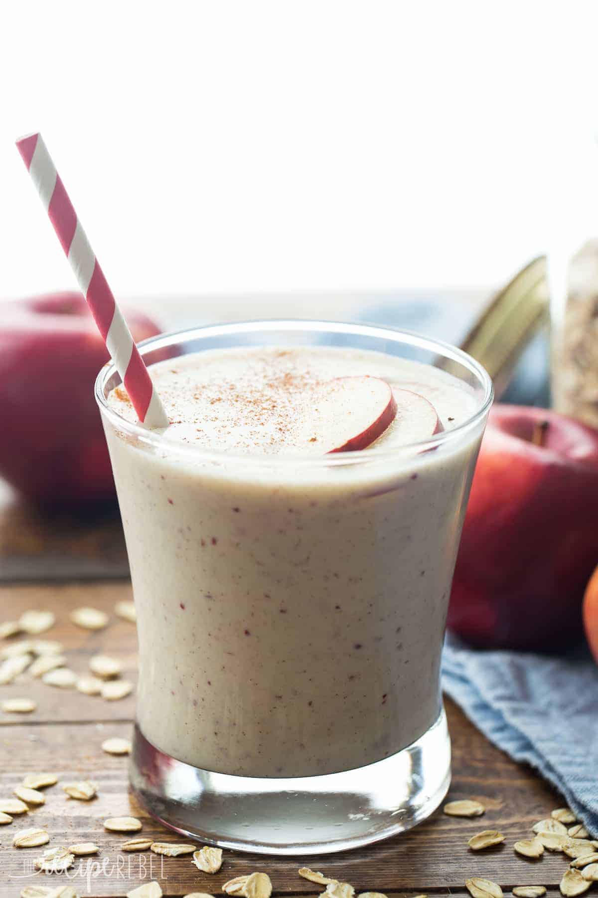 small glass with apple crisp smoothie dusted with cinnamon and red striped straw