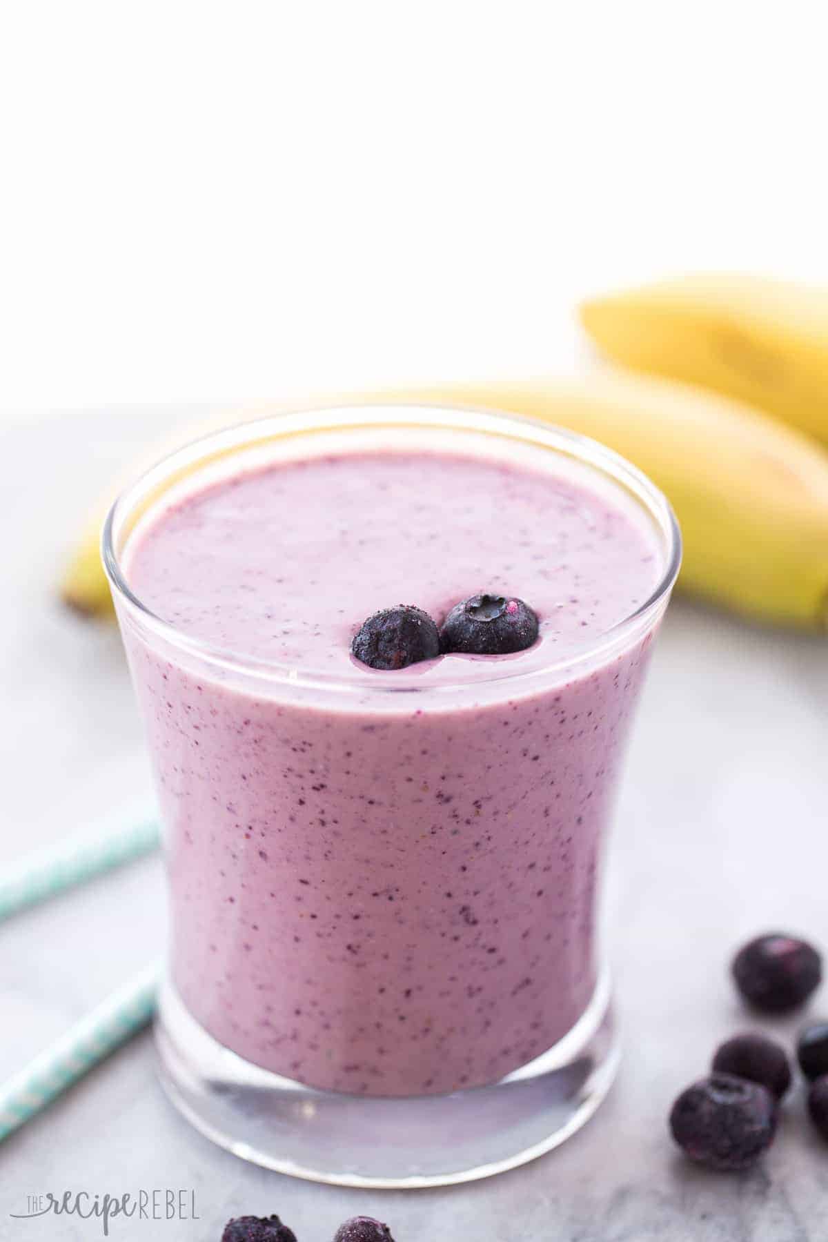 A healthy breakfast or snack to boost your metabolism and fill you up! You'll never guess my secret ingredient ;) purple metabolism boosting smoothie in glass with two blueberries on top