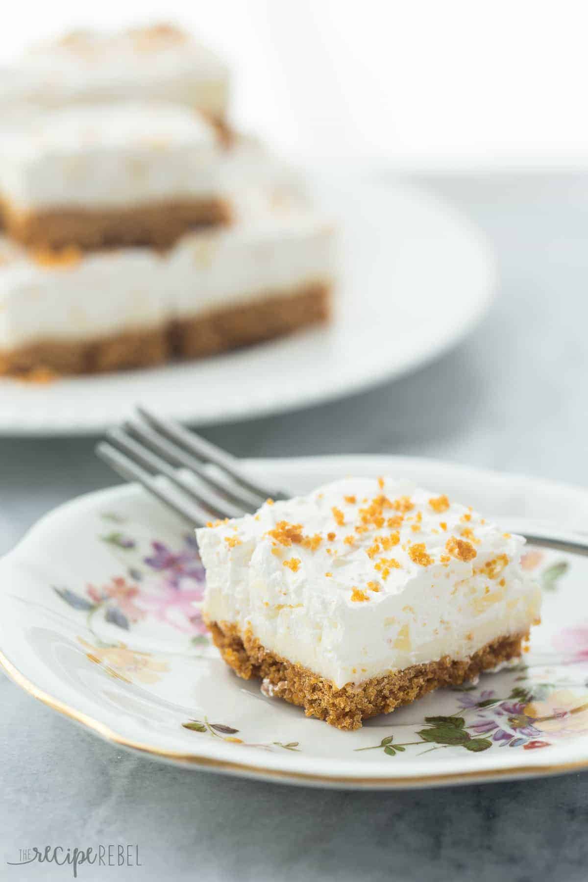 one piece of pineapple squares on a floral saucer with a fork