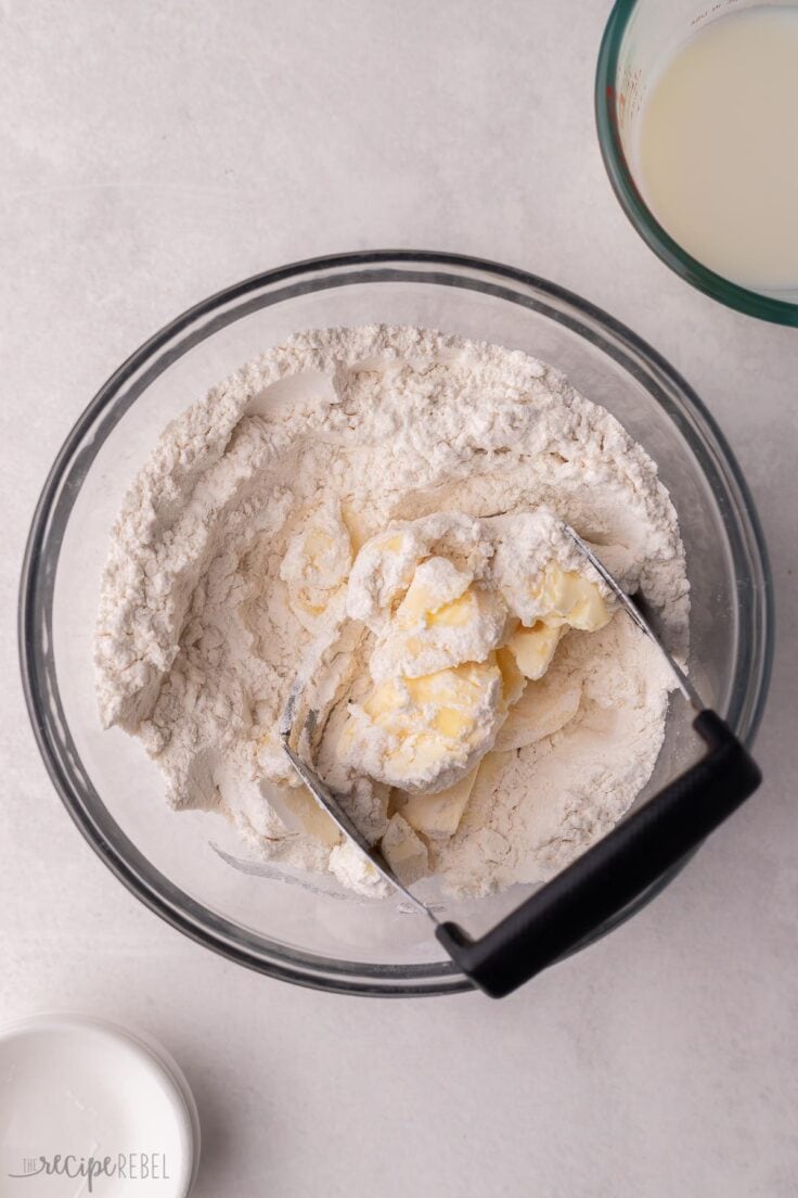 cold butter being cut into dry ingredients for biscuits.