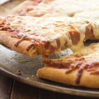 Step by step guide to making and freezing homemade frozen pizzas so you can enjoy them later! A freezer meal the whole family will love :)