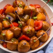 square image of slow cooker pineapple brown sugar meatballs with toothpicks.