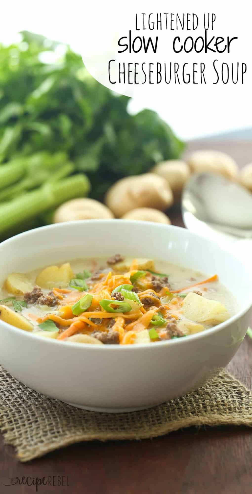 slow cooker cheeseburger soup in white bowl topped with cheddar cheese and green onions