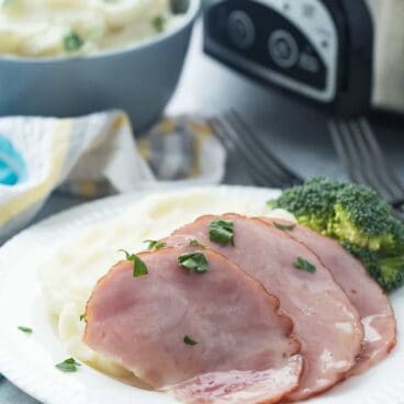 This Slow Cooker Honey Glazed Ham is so easy and perfect for Easter or holiday gatherings! There's one secret ingredient that really makes the glaze extra special ;)