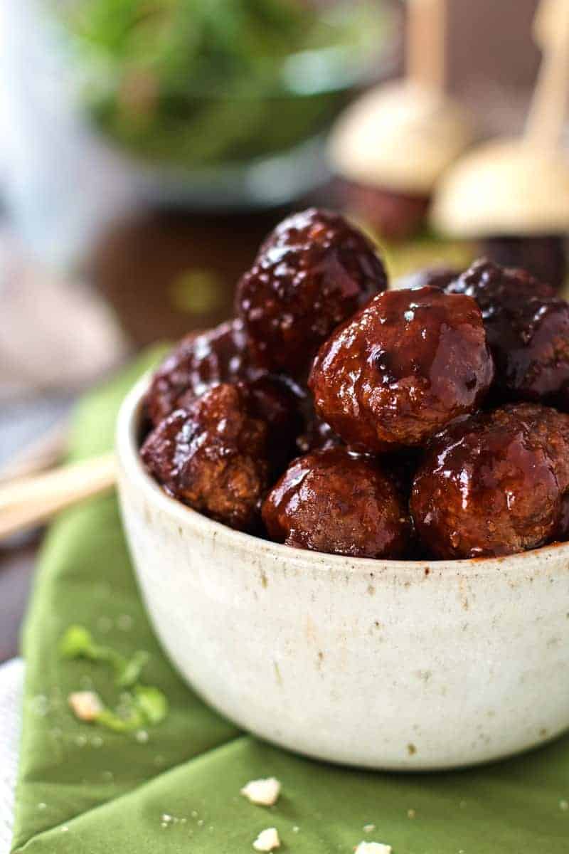 bbq slow cooker meatballs in white bowl close up