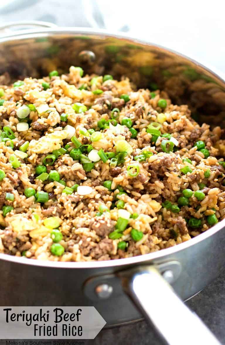 teriyaki beef fried rice in a skillet with green onions on top