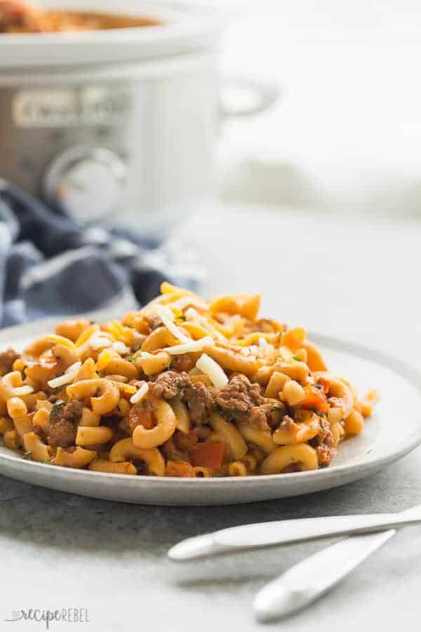 A healthier, homemade version of Hamburger Helper made completely in the slow cooker -- yes, even the pasta! (And no, it's not mushy and overcooked!) Packed with sneaky veggies. #slowcooker #crockpot #pasta #recipe #dinner #healthy #healthyfood hamburger helper with slow cooker in the background and blue striped towel