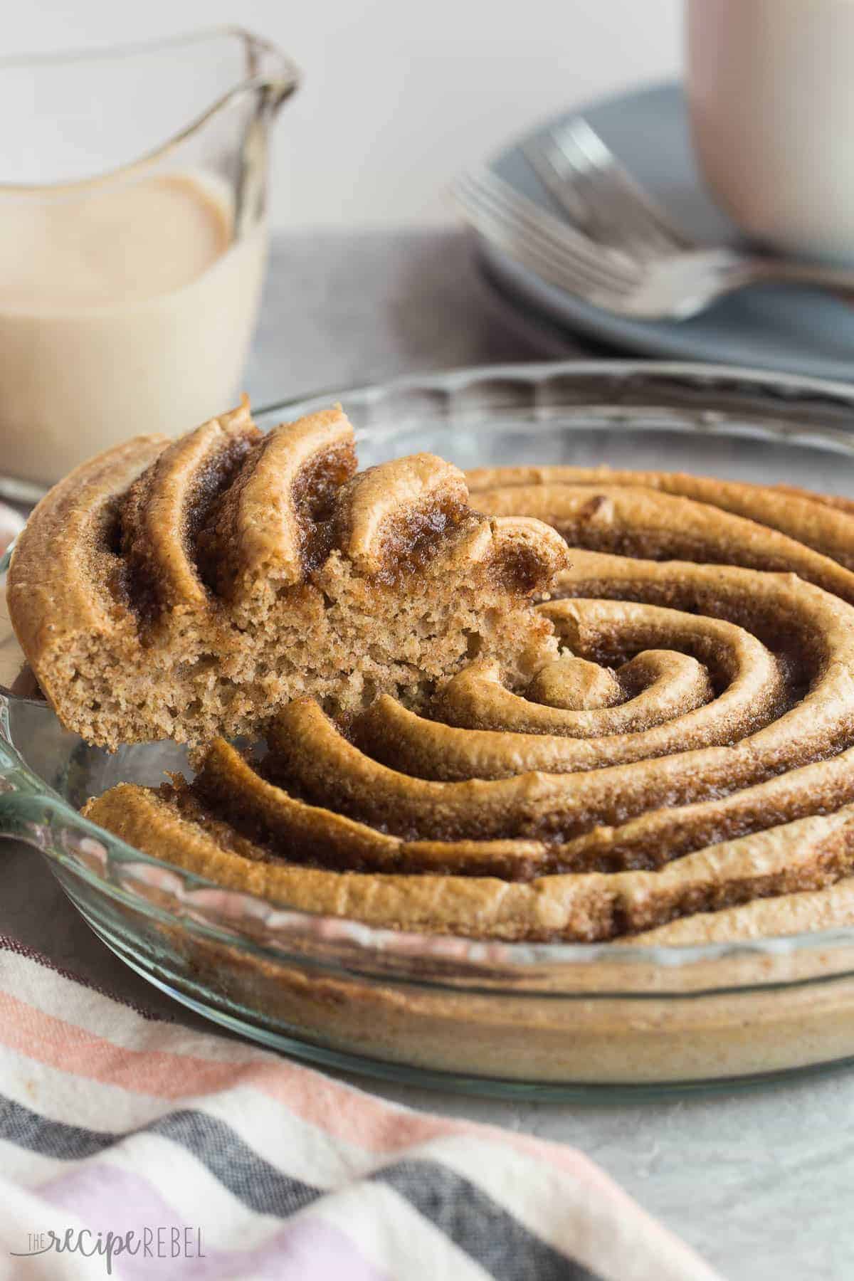 piece of cinnamon roll pancake being scoop with metal server from pan