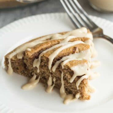 This Healthier Cinnamon Roll Baked Pancake is whole wheat, low in sugar, and bakes in a pie plate so there's no flipping or waiting! Drizzle with easy Maple Cream Cheese Syrup for a special treat!