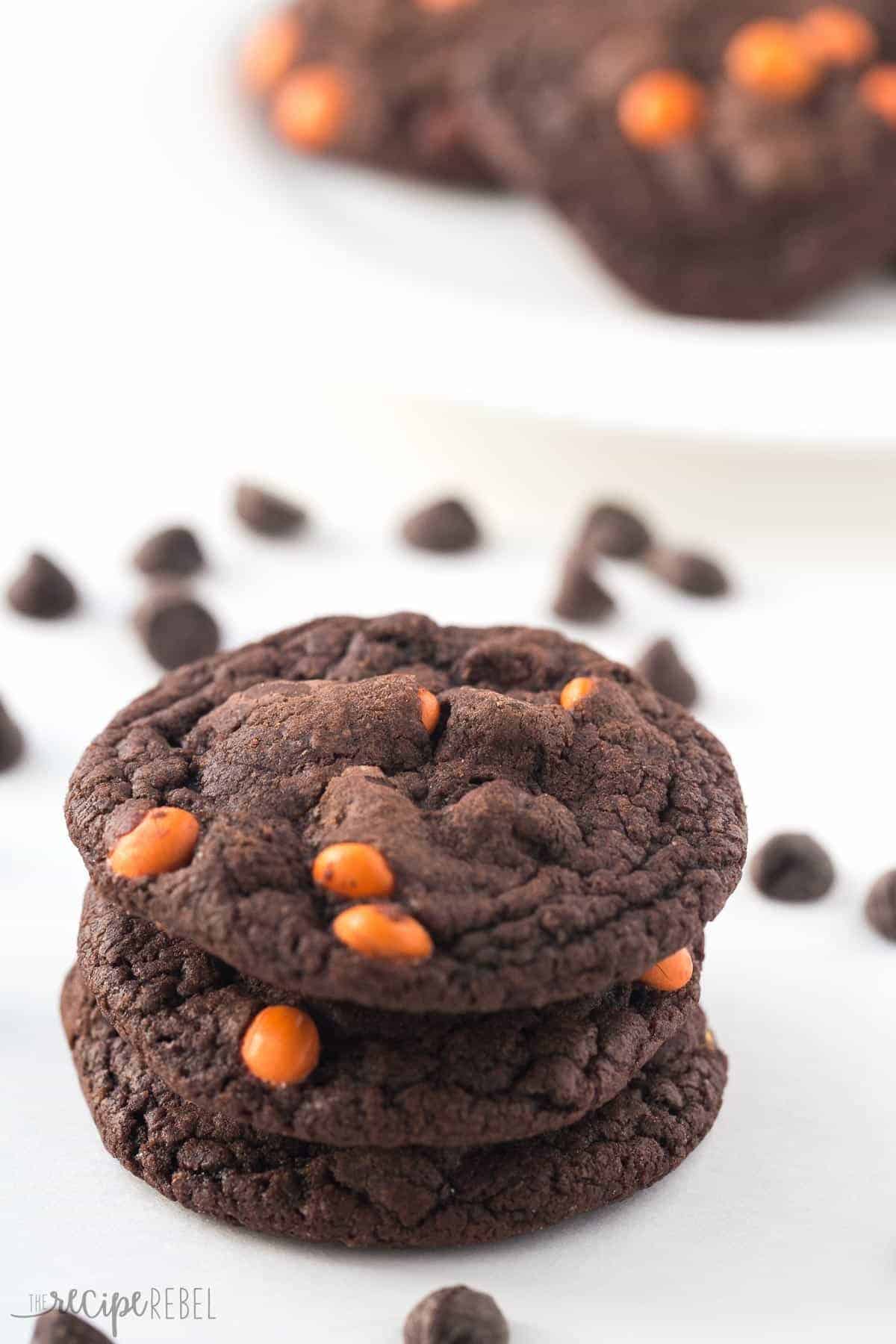 stack of three reeses pieces chocolate cookies with chocolate chips all around