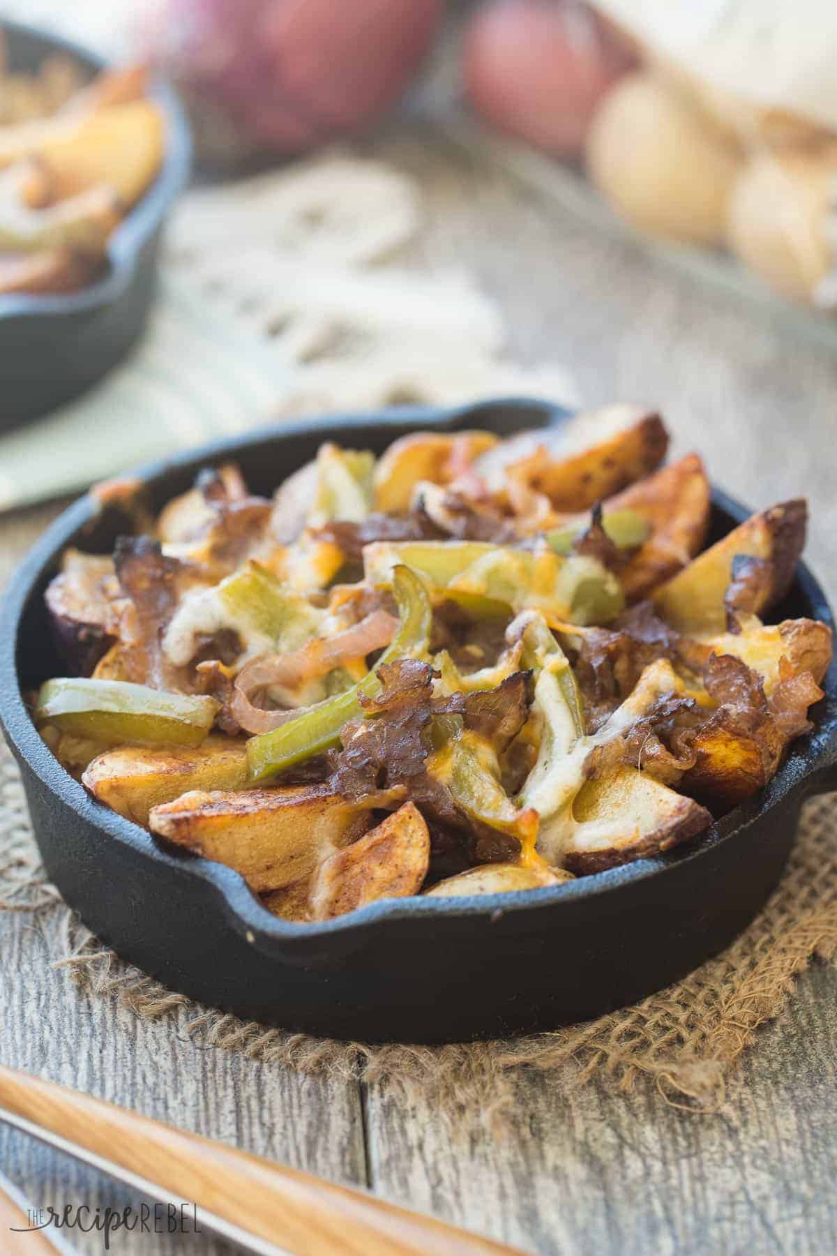 seasoned potato wedges with peppers and beef and cheese in skillet