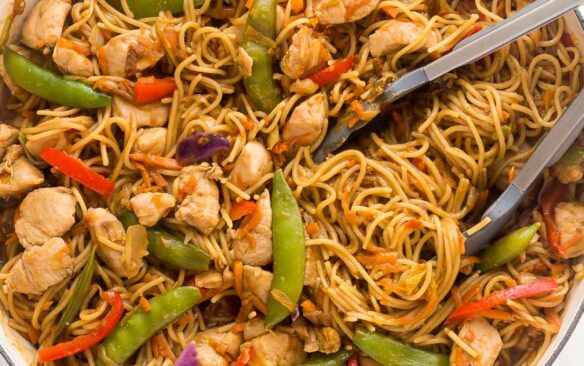 overhead image of chicken chow mein in large white skillet