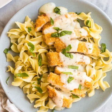 crispy chicken breasts sliced over egg noodles with creamy basil sauce