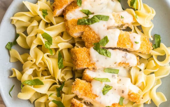 crispy chicken breasts sliced over egg noodles with creamy basil sauce