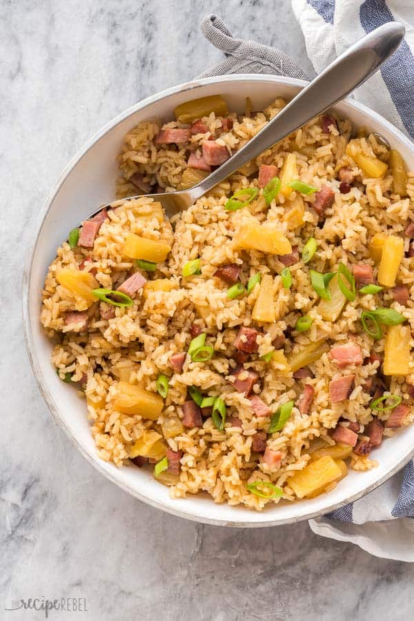ham and pineapple rice overhead in white pan on marble