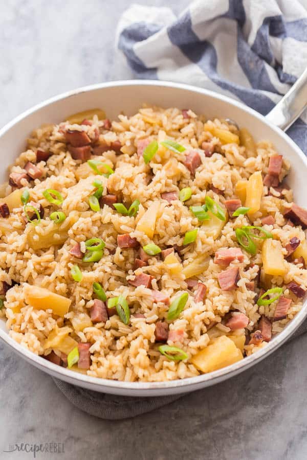 ham and pineapple rice in white pan on marble with white and blue towel