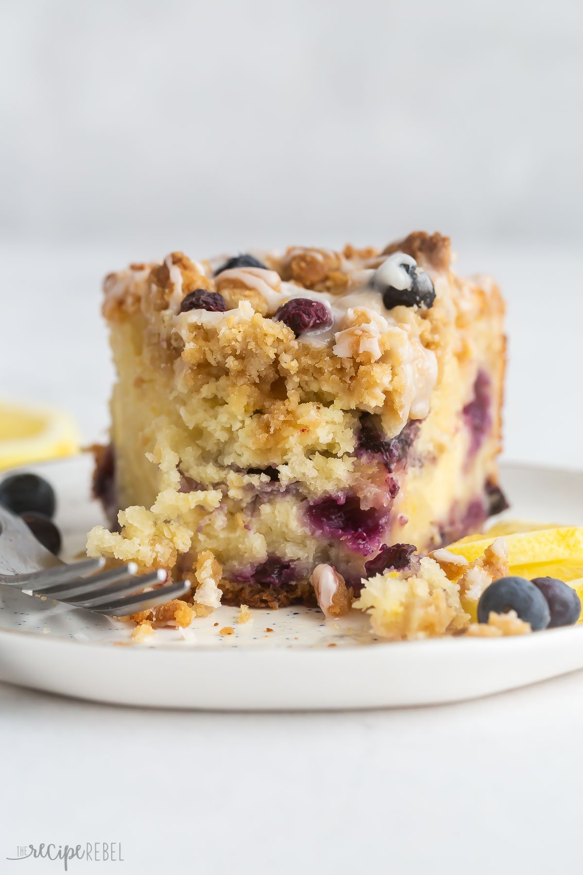 close up image of piece of lemon coffee cake with bite taken