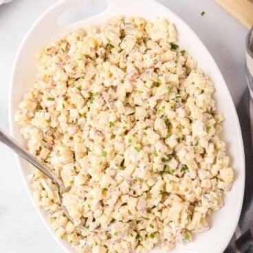 overhead image of potato salad in large white serving bowl