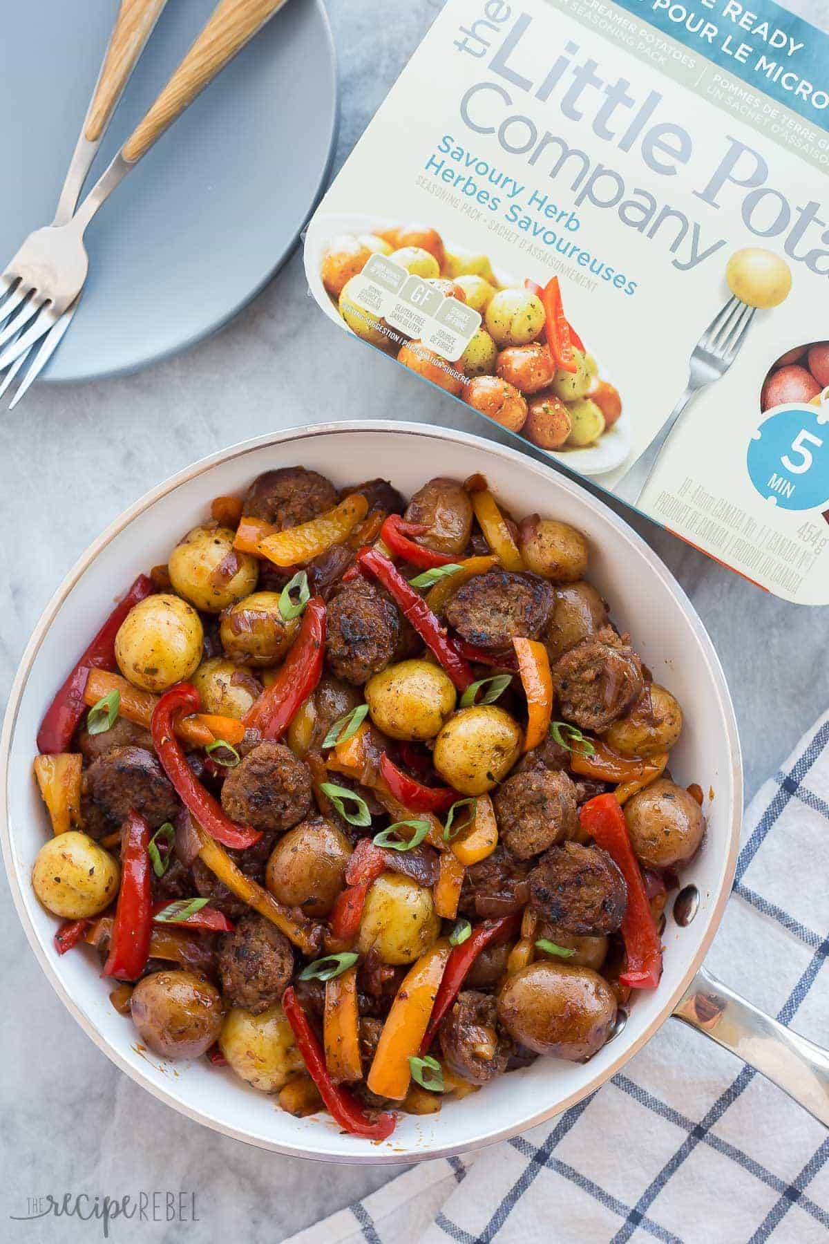 The BEST, EASIEST meal I've made in a long time! This 30 Minute BBQ Sausage, Peppers and Potato Skillet is a hearty, healthy, easy meal that only needs one pot, and it's gluten free! overhead image of potatoes sausage and peppers in white skillet with little potatoes