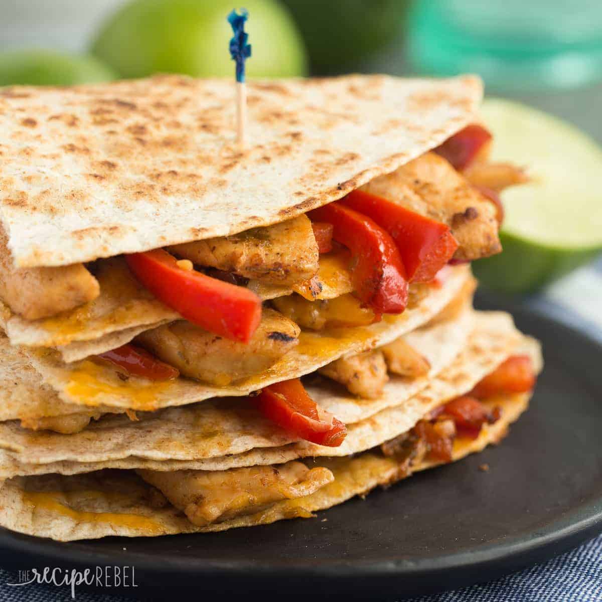 square image of stack of honey lime chicken quesadillas on black plate