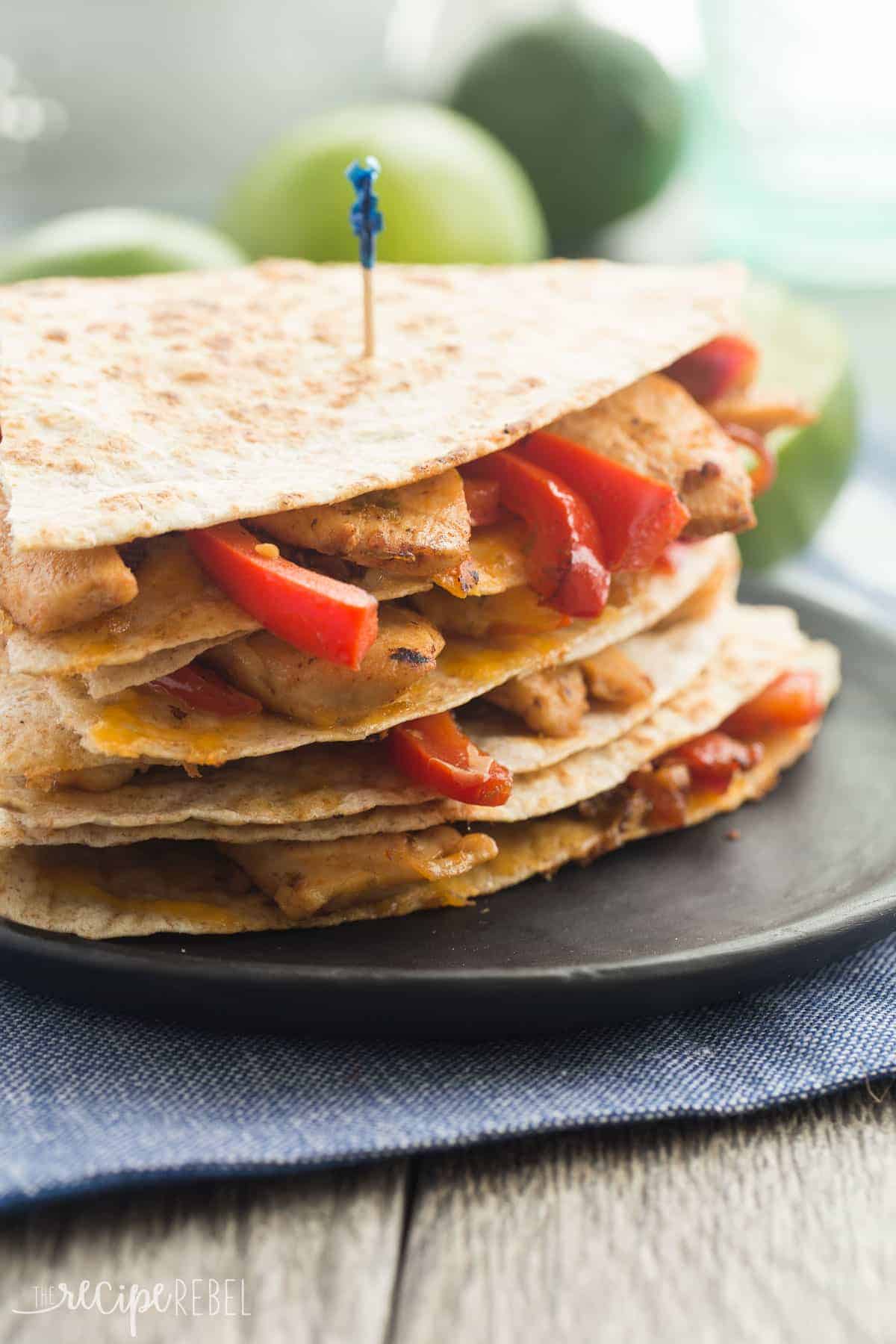 stack of honey lime chicken quesadillas on a black plate up close