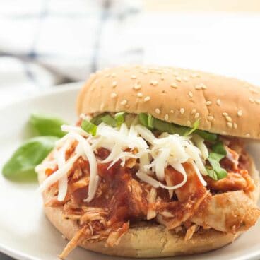 A SUPER simple, flavorful meal with just a few ingredients! These Slow Cooker Italian Chicken Sandwiches are perfect for picnics or weeknights! Gluten free and paleo options.