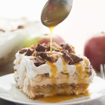 This Snickers Apple Icebox Cake is an easy, no bake dessert based off the popular Snickers Apple Salad! Layers of peanut butter cheesecake, graham crackers, caramel sauce and apples all topped with Snickers!