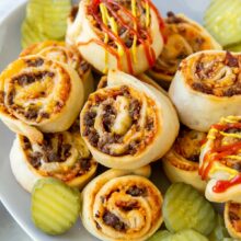 cheeseburger buns in plate with ketchup and mustard drizzled