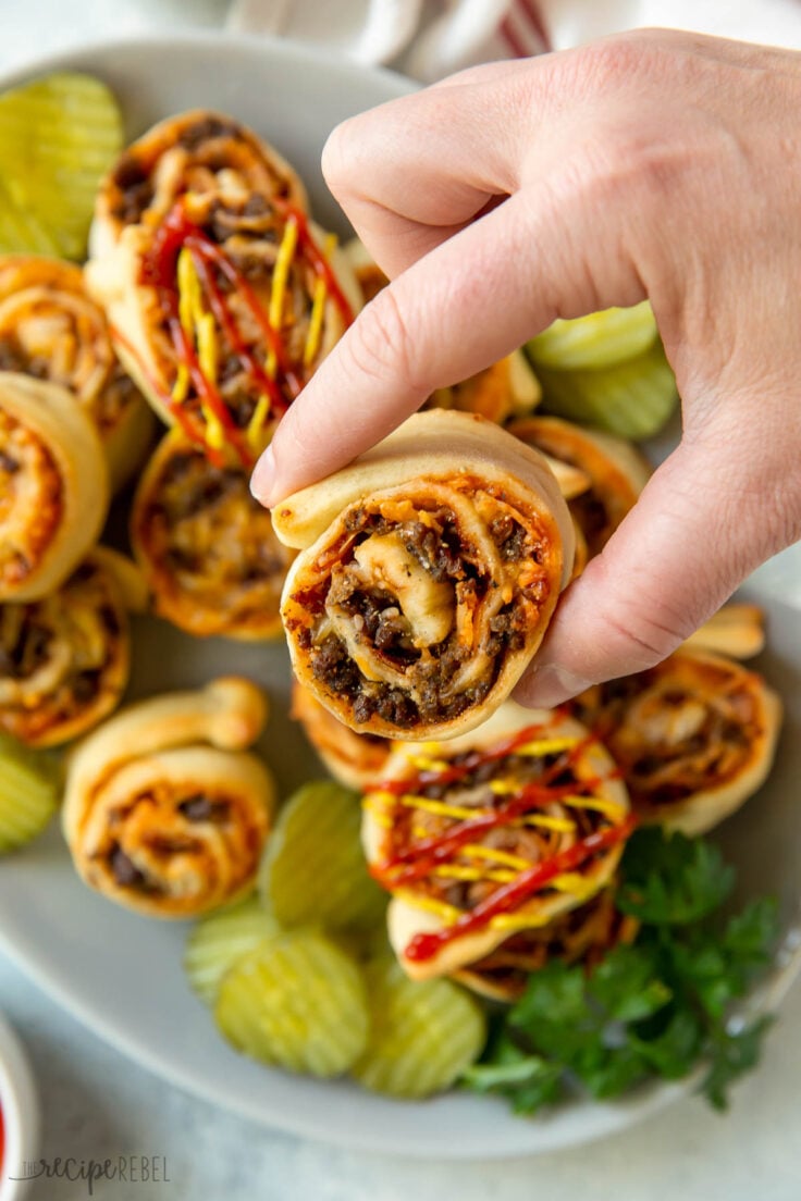 hand holding up bbq bacon cheeseburger bun